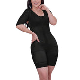 Woman wearing a black body shaper against a white background